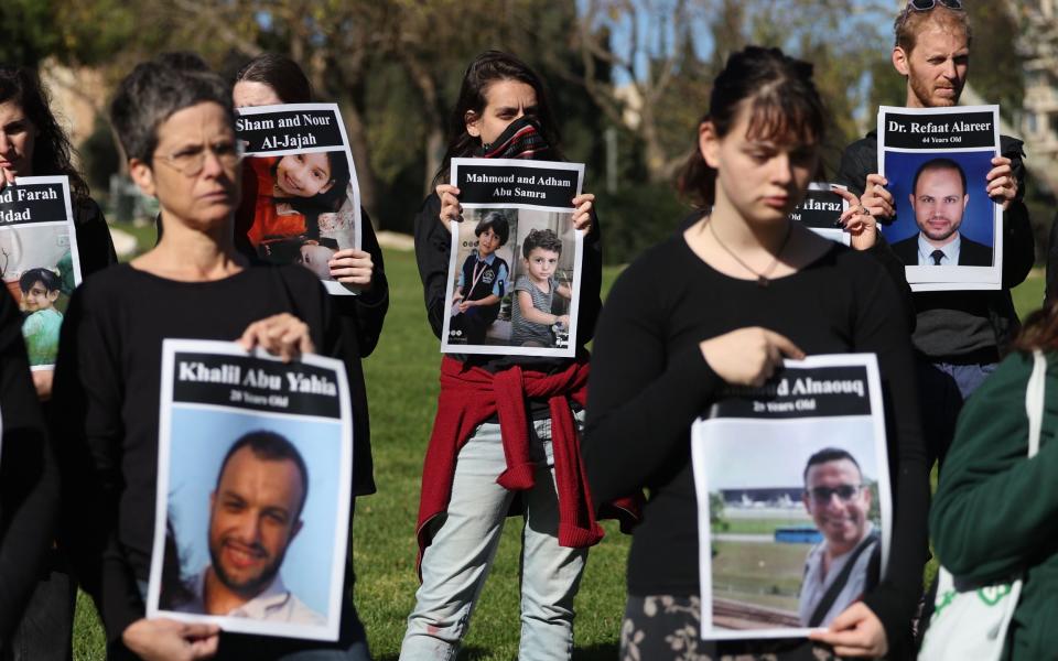 Mandatory Credit: Photo by ABIR SULTAN/EPA-EFE/Shutterstock (14269183d) Israelis hold pictures of Palestinian victims who died during the Israeli-Hamas conflict as they call for a ceasefire outside the US consulate in central Jerusalem, 22 December 2023. More than 19,600 Palestinians and at least 1,200 Israelis have been killed, according to the Palestinian Health Ministry and the Israel Defense Forces (IDF), since Hamas militants launched an attack against Israel from the Gaza Strip on 07 October, and the Israeli operations in Gaza and the West Bank which followed it. Israelis hold vigil for Palestinian victims outside the US consulate in Jerusalem - 22 Dec 2023