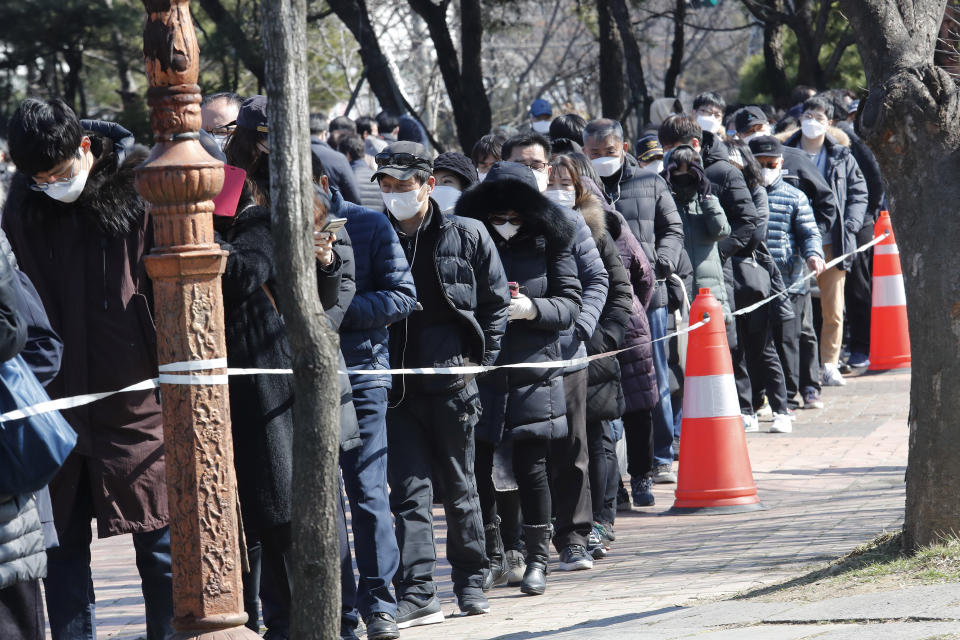 People line up to buy face masks to protect themselves from the new coronavirus outside Nonghyup Hanaro Mart in Seoul, South Korea, Thursday, March 5, 2020. The number of infections of the COVID-19 disease spread around the globe. (AP Photo/Ahn Young-joon)