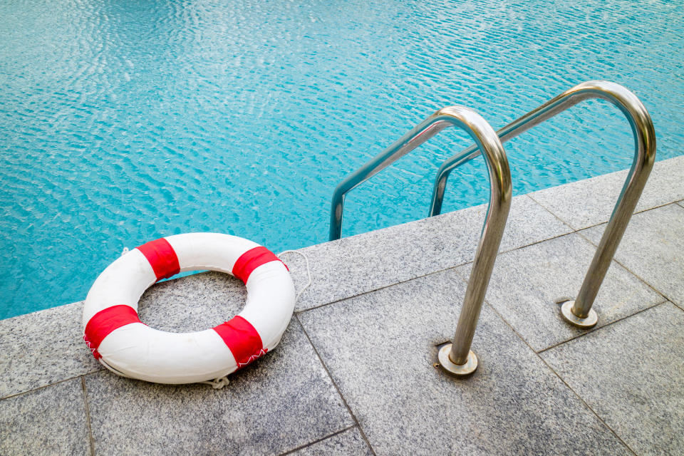 pool with ladder and lifeguard ring