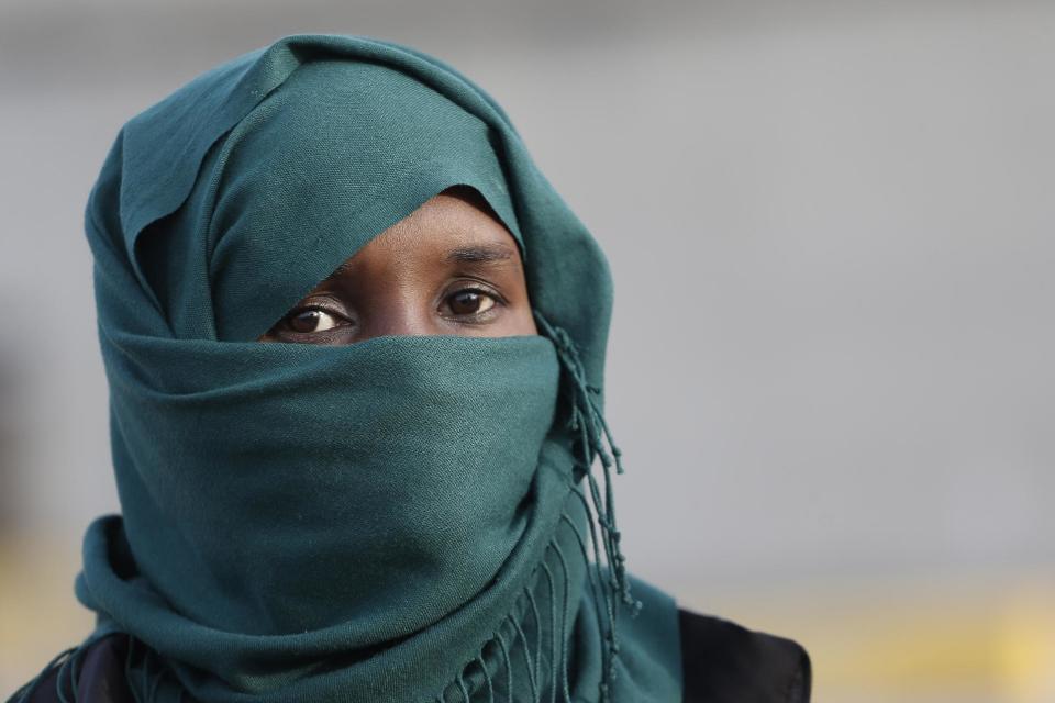 An African immigrant, one of the 32 from Syria and Somalia who survived from one of the deadliest migrant boat accidents which occurred on May 5 in Greek waters, arrives at the port of Piraeus, near Athens, on Monday, May 12, 2014. At least 22 people, including families trapped in a flooded cabin, drowned when a yacht and a dinghy crammed with migrants trying to slip into Greece capsized last week in the eastern Aegean Sea, next to the island of Samos, authorities said. (AP Photo/Petros Giannakouris)