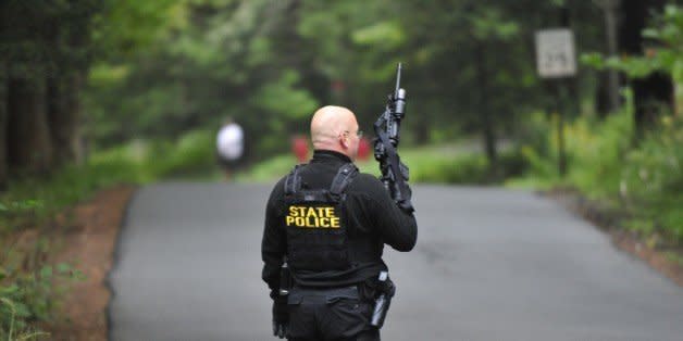 Police surround a neighborhood in the Pocono Mountains in search of suspect Eric Frein on Saturday, Sept. 20, 2014 in Canandensis, Pa.  Police have charged Frein with opening fire outside a state police barracks in northeastern Pennsylvania on Sept. 12. Cpl. Bryon Dickson was killed and Trooper Alex Douglass was wounded by the gunman with a high-powered rifle. (AP Photo/Chris Post) (Photo: )