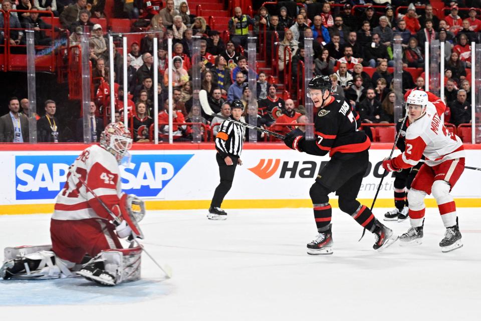 Ottawa Senators' Brady Tkachuk, Detroit Red Wings' Olli Maatta and goalkeeper James Reimer look at the puck during the NHL Global Series 2023 in the Avicii Arena in Stockholm, Sweden, on November 16, 2023.