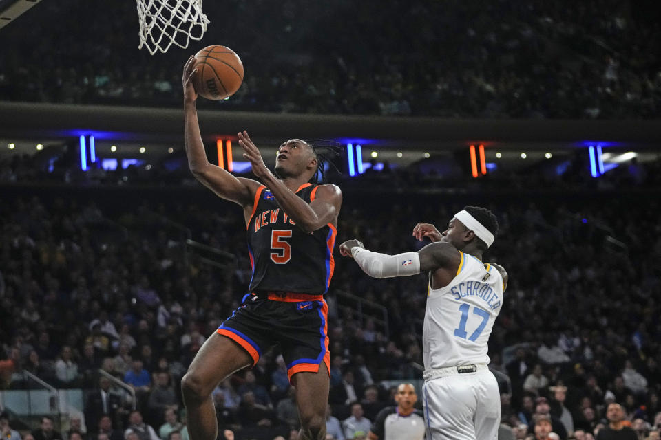 New York Knicks' Immanuel Quickley (5) drives past Los Angeles Lakers' Dennis Schroder (17), of Germany, during the first half of an NBA basketball game Tuesday, Jan. 31, 2023, in New York. (AP Photo/Frank Franklin II)
