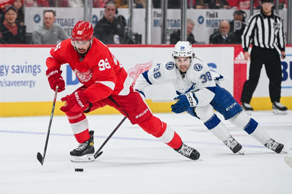 Detroit Red Wings defenseman Jake Walman (96) brings the puck up ice against Tampa Bay Lightning left wing Brandon Hagel (38) during the second period at Little Caesars Arena in Detroit on Saturday, Feb. 25, 2023.