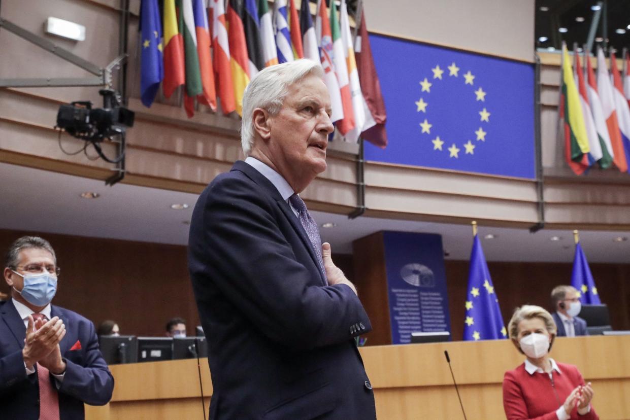 Head of the Task Force for Relations with the UK, Michel Barnier (C), flanked by European Commission President Ursula von der Leyen (R) gestures during the debate on EU-UK trade and cooperation agreement during the second day of a plenary session at the European Parliament in Brussels, on April 27, 2021. (Photo by OLIVIER HOSLET / POOL / AFP) (Photo by OLIVIER HOSLET/POOL/AFP via Getty Images)