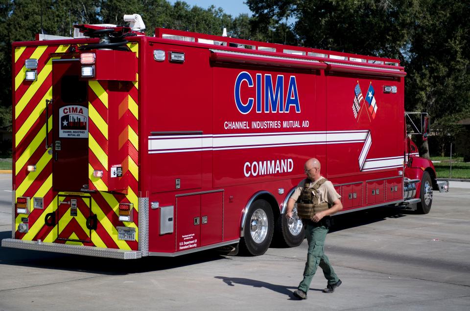 <p>A Harris County Sheriff walks by a Channel Industries Mutual Aid firetruck at the Crosby volunteer fire department after a chemical plant operated by the Arkema Group had an explosion during the aftermath of Hurricane Harvey on Aug. 31, 2017 in Crosby, Texas. (Photo: Brendan Smialowski/AFP/Getty Images) </p>