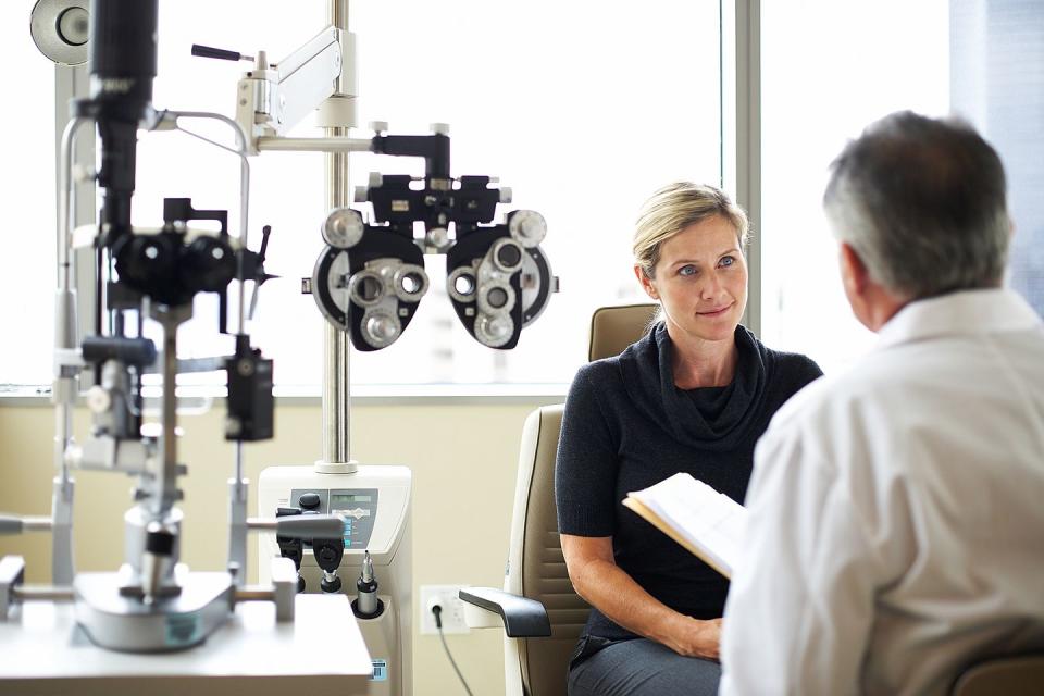 a woman listens to her opthamologist