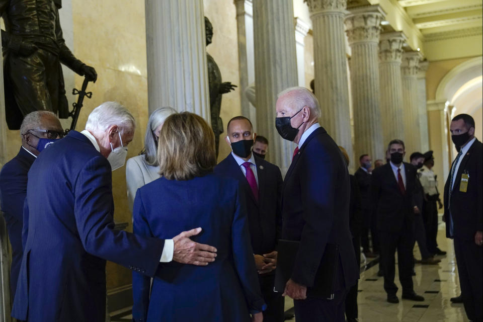 President Joe Biden talks with House Majority Whip James Clyburn of S.C., left, House Majority Leader Steny Hoyer of Md., second from left, House Speaker Nancy Pelosi of Calif., center, and Rep. Hakeem Jeffries, D-N.Y., as he arrives on Capitol Hill in Washington, Friday, Oct. 1, 2021, for a meeting with the House Democratic caucus to try to resolve an impasse around the bipartisan infrastructure bill. (AP Photo/Susan Walsh)