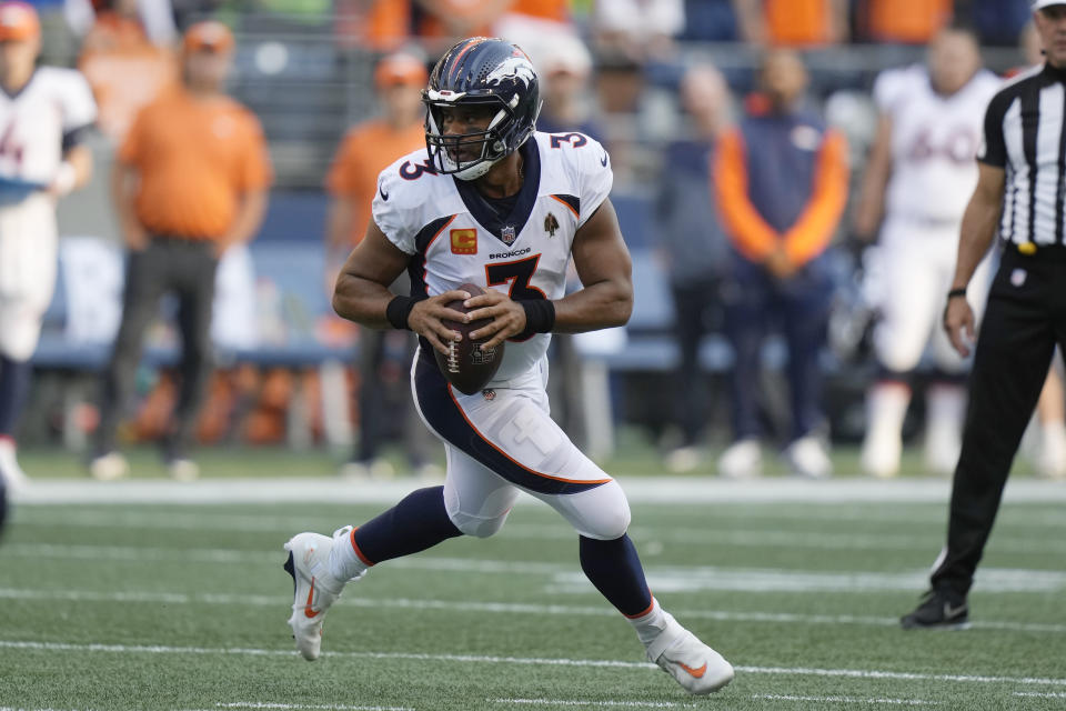 Denver Broncos quarterback Russell Wilson drops to pass against the Seattle Seahawks during the first half of an NFL football game, Monday, Sept. 12, 2022, in Seattle. (AP Photo/Stephen Brashear)