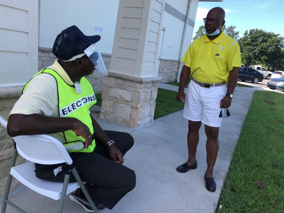 Robert Willis, right, greets a poll deputy outside the Dr. Joe Lee Smith Community Center in Cocoa. Willis, a candidate for the Democratic nomination in the Florida governor's race, is a teacher at Emma Jewel Charter Academy.