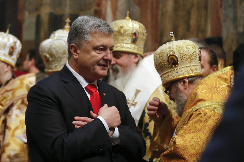 Ukrainian President Petro Poroshenko attends the enthronement of the newly elected head of the Orthodox Church of Ukraine, Metropolitan of Kyiv and All Ukraine Epiphanius in the St. Sophia Cathedral in Kiev, Ukraine, Sunday, Feb. 3, 2019. Epiphanius has been elected to head the new Ukrainian church independent from the Russian Orthodox Church. (AP Photo/Efrem Lukatsky)