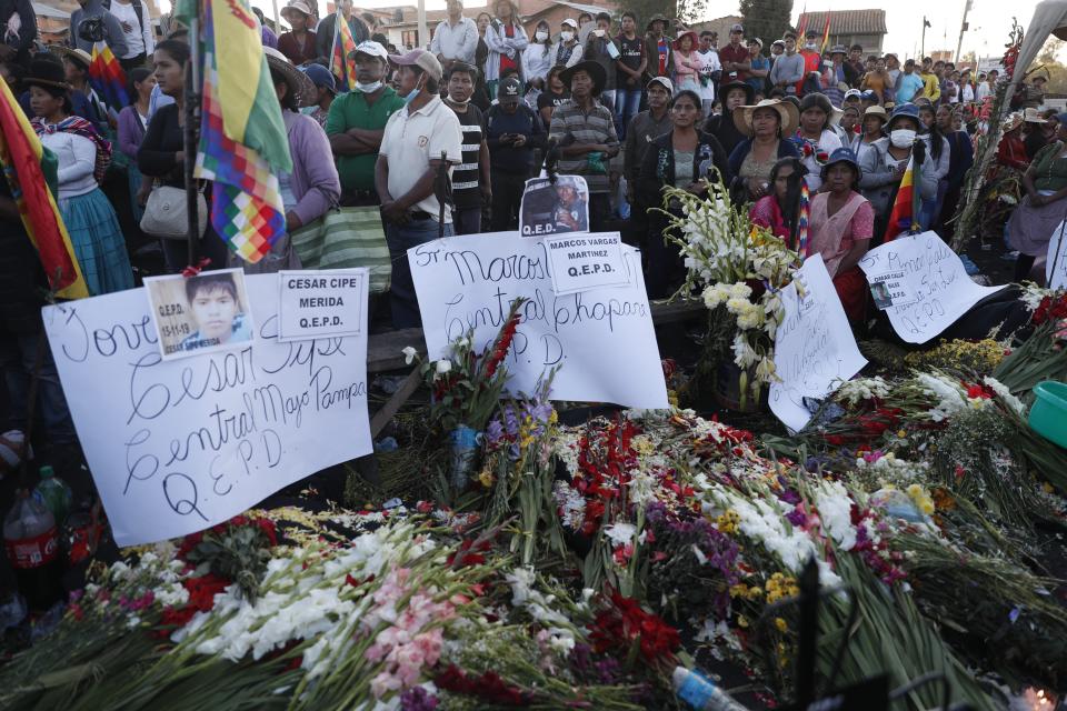 Supporters of former President Evo Morales set up memorials for those killed on Saturday when government forces opened fire on them, in Sacaba, Bolivia, Sunday, Nov. 17, 2019. Bolivia's political crisis turned deadly after security forces opened fire on supporters of former President Evo Morales in Sacaba on Nov. 15, killing multiple people and injuring dozens. (AP Photo/Juan Karita)