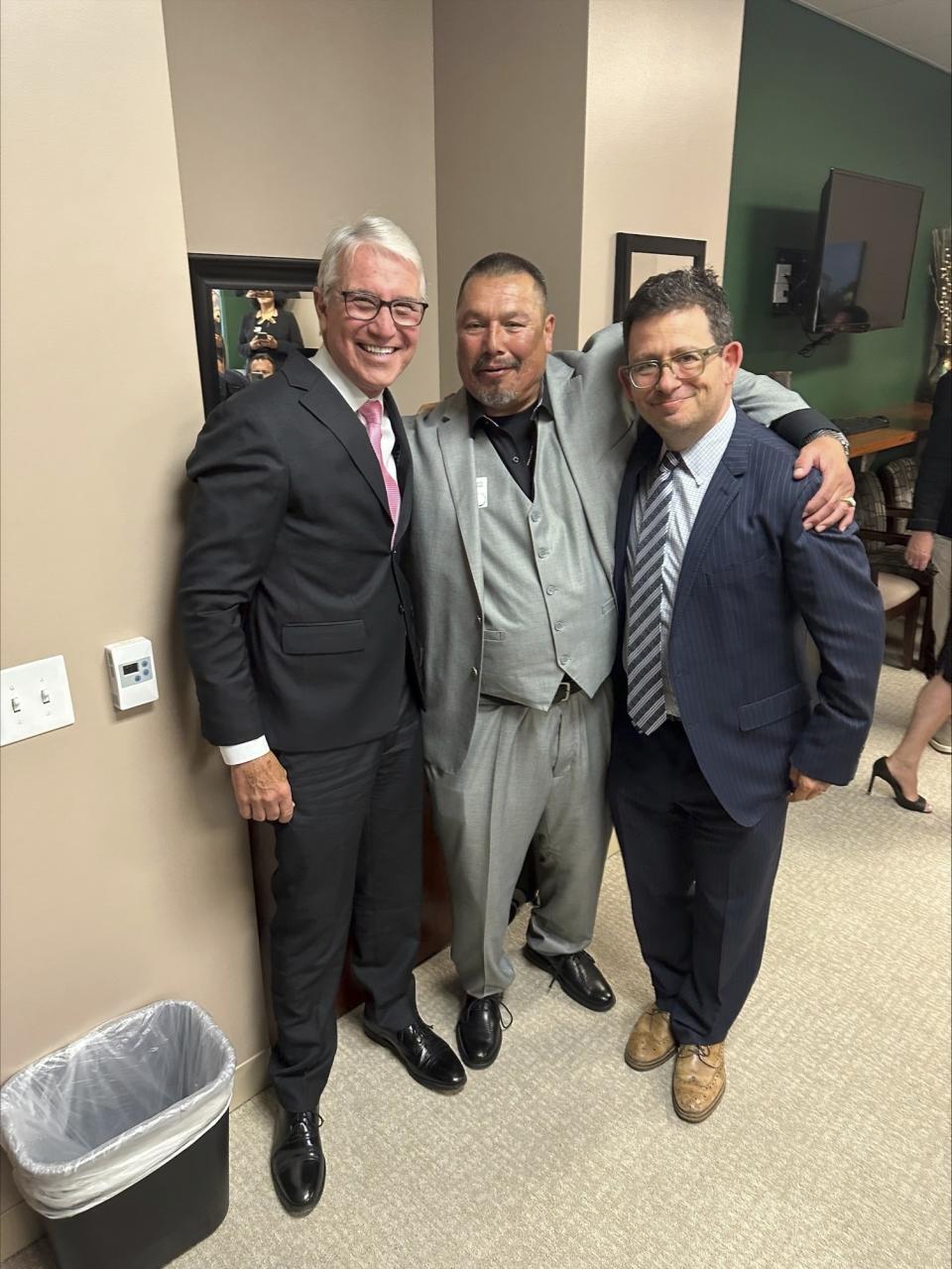 This undated photo, provided the by Los Angeles District Attorney's Office, shows Daniel Saldana, center, with Los Angeles District Attorney George Gascon, left, and Saldana's lawyer Mike Romano. Saldana, who spent 33 years in California prison for attempted murder, has been declared innocent and freed. (Los Angeles County District Attorney's Office via AP)