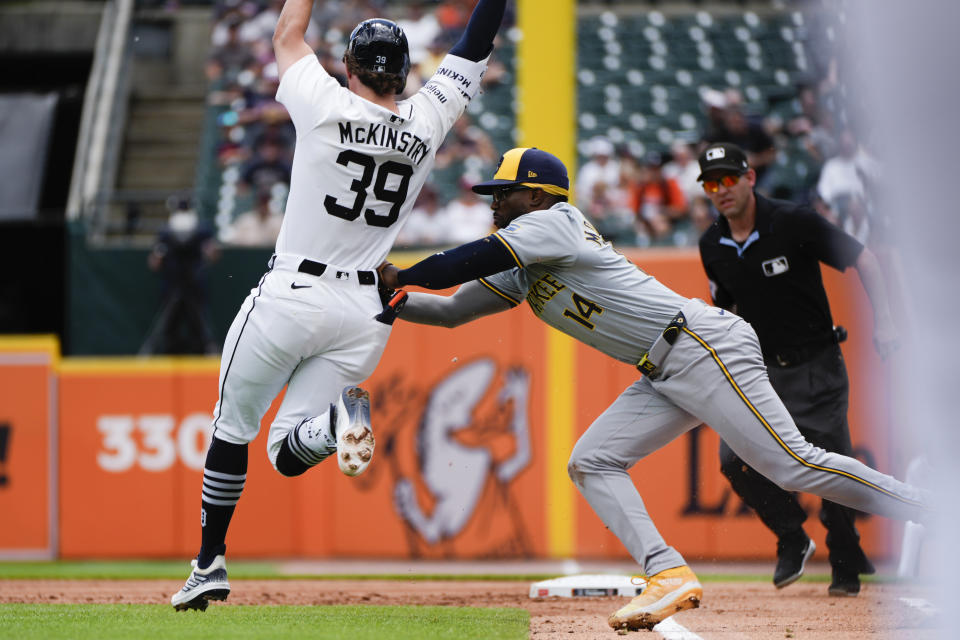 Milwaukee Brewers first baseman Andruw Monasterio (14) tags Detroit Tigers' Zach McKinstry (39) out running to first base in the first inning of a baseball game, Sunday, June 9, 2024, in Detroit. (AP Photo/Paul Sancya)