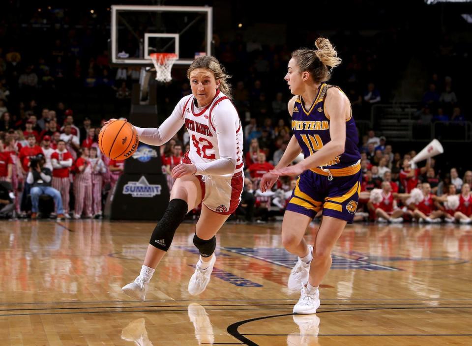 SIOUX FALLS, SD - MARCH 5: Maddie Krull #42 of the South Dakota Coyotes pushes the ball past Elizabeth Lutz #14 of the Western Illinois Leathernecks at The Summit League Basketball Tournament at the Denny Sanford Premier Center on March 5, 2022 in Sioux Falls, South Dakota. (Photo by Dave Eggen/Inertia)