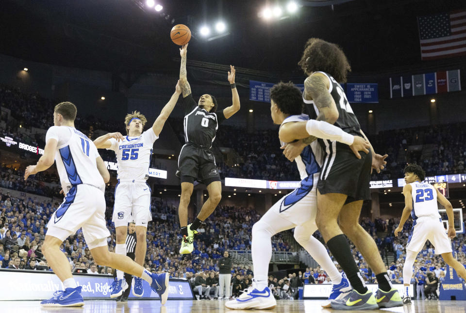 Providence's Alyn Breed (0) shoots over Creighton's Baylor Scheierman (55) during the first half of an NCAA college basketball game on Saturday, Jan. 14, 2023, in Omaha, Neb. (AP Photo/Rebecca S. Gratz)