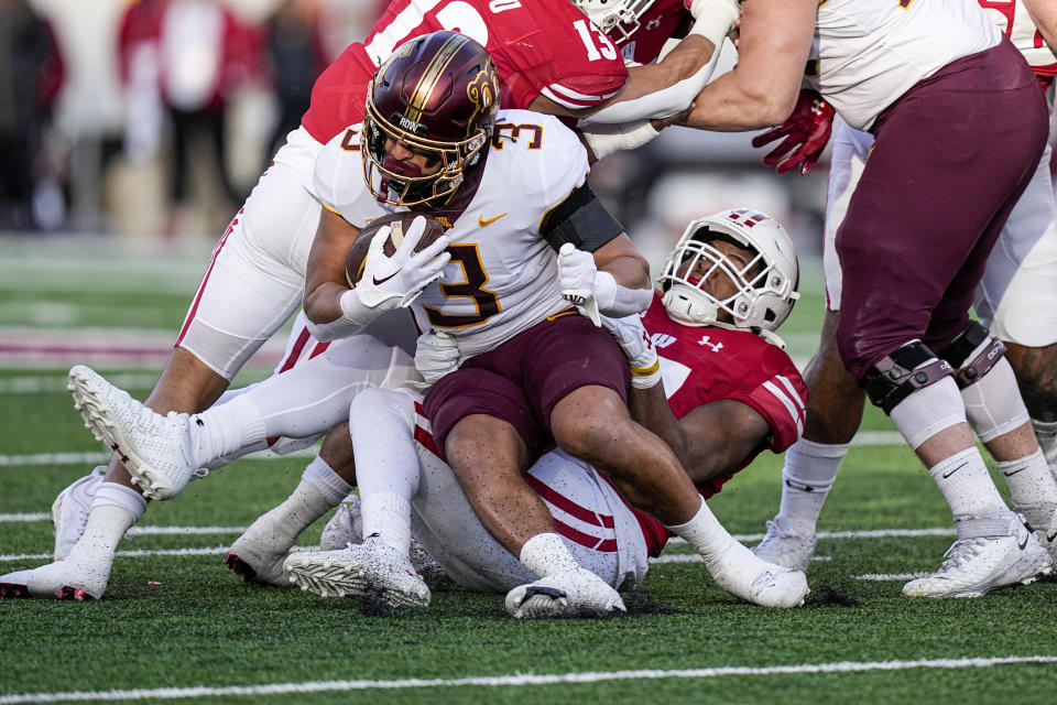 Wisconsin linebacker Darryl Peterson (17) tackles Minnesota running back Trey Potts (3) during the first half of an NCAA college football game Saturday, Nov. 26, 2022, in Madison, Wis. (AP Photo/Andy Manis)