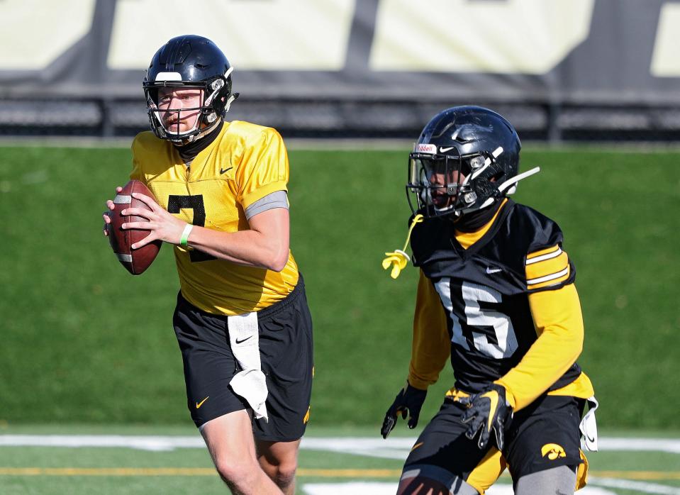 Iowa&#39;s new starting quarterback, Spencer Petras, looks to pass during Monday&#39;s practice session. Running back Tyler Goodson is to his left. Petras only attempted 10 passes a year ago, but expectations are high that the redshirt sophomore can ignite a potent Hawkeye offense.
