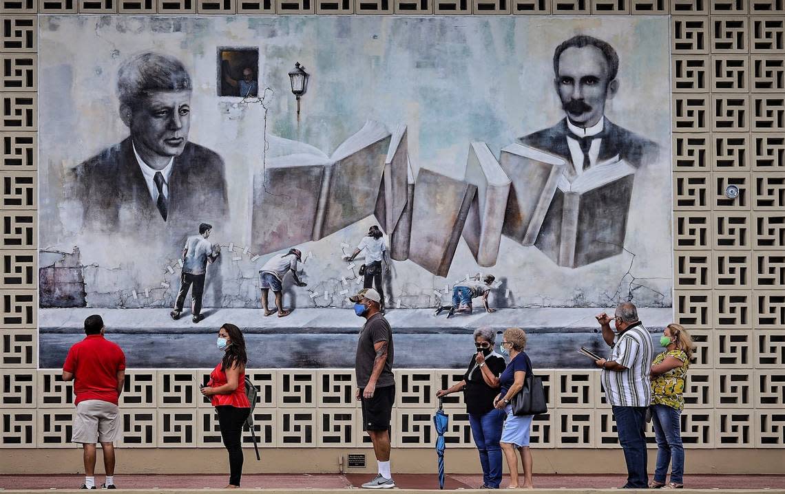 A steady flow of voters stands in line in front of the large mural outside the JFK Library in Hialeah, as Florida began its first day of early voting in this October 2020 file photo.