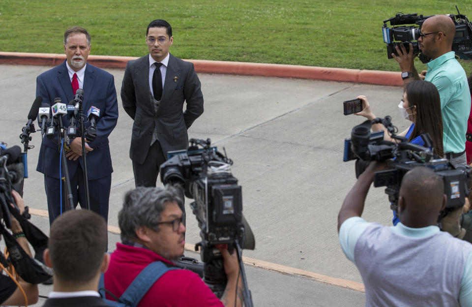 Victor Hugo Cuevas, a 26-year-old linked to a missing tiger named India, and his attorney Michael Elliott, left, talk to reporters before entering Fort Bend County Justice Center for a bond revocation hearing on a separate murder charge, on Friday, May 14, 2021, in Richmond, Texas. (Godofredo A. Vásquez/Houston Chronicle via AP)