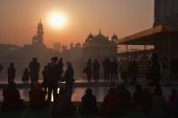 <p>Indian Sikh devotees pay respects on the first day of the year at the Golden Temple in Amritsar on January 1, 2016. </p>