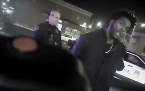 NBA Bucks guard Sterling Brown talks to arresting police officers after being shot by a stun gun  - Credit: AP