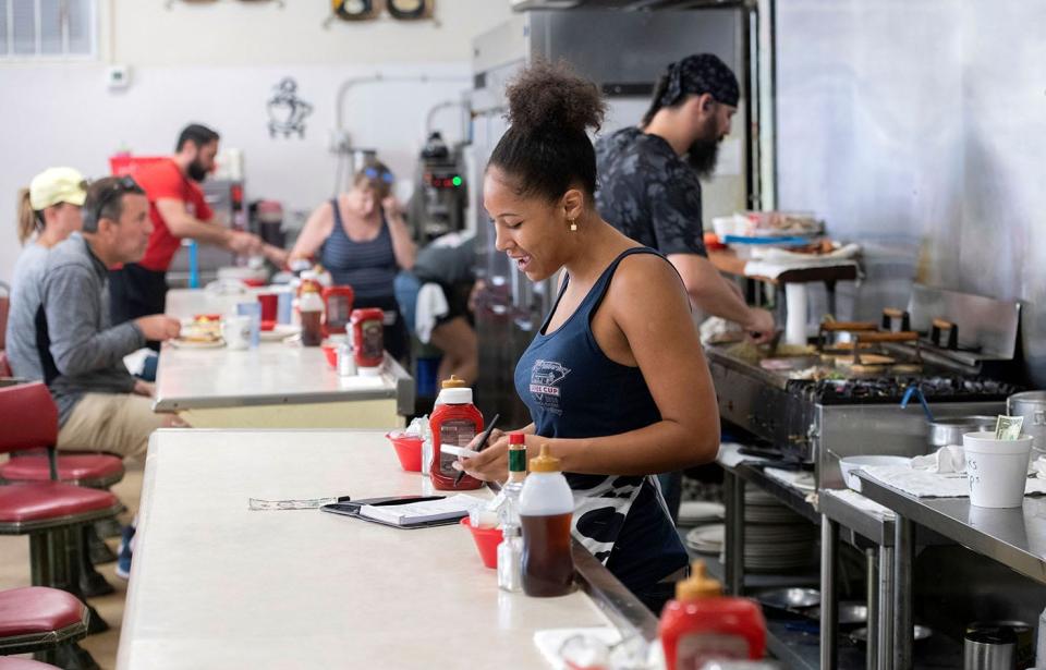 Servers like this one at the Coffee Cup restaurant in downtown Pensacola got a bump in pay as Florida increased its minimum wage. While DeSantis criticized the amendment, new data from state economists suggests the increase is actually helping pad the pockets of Floridians.