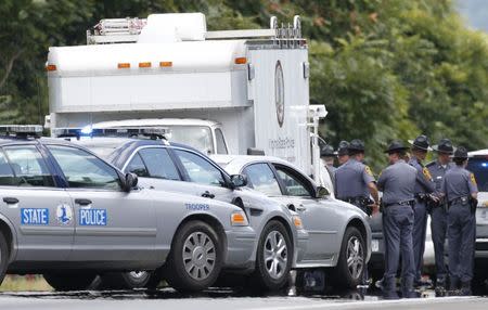 Virginia State Police vehicles line the edge of Highway I-66 in Fauquier County, Virginia, where shooting suspect 41-year-old Vester Flanagan shot and wounded himself several hours after two television journalists were shot and killed during a live broadcast in Virginia on Wednesday in an attack authorities said was carried out by Flanagan, police said August 26, 2015. REUTERS/Kevin Lamarque