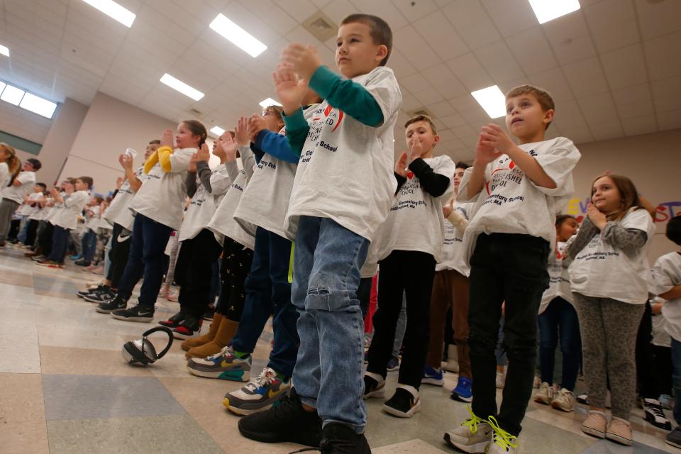 Students give themselves a standing ovation to celebrate the Acushnet Elementary School being designated a National ESEA Distinguished School.