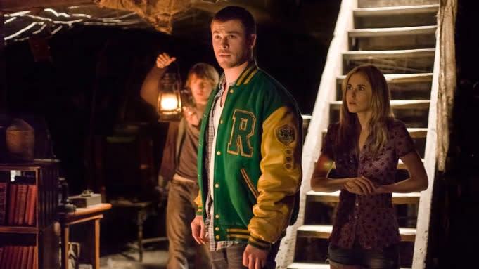 Teens stand in a basement in a still from Cabin in the Woods. 