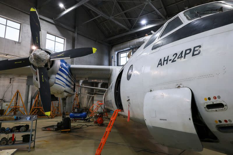 A Polar Airlines' Antonov An-24 passenger aircraft is serviced at an airport in Yakutsk