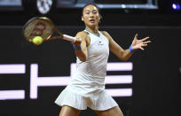 China's Qinwen Zheng returns the ball to Romania's Sorana Cristea during the Porsche Tennis Grand Prix WTA tennis tournament in Stuttgart, Germany, Tuesday, April 16, 2024. (Marijan Murat/dpa via AP)