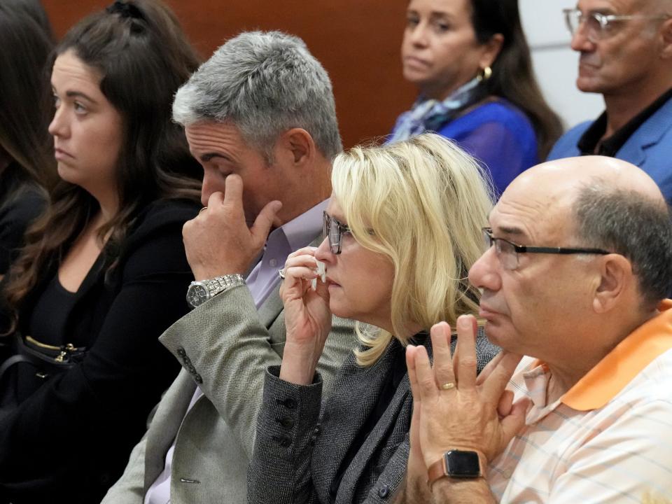 From left; Abby Hoyer, Tom and Gena Hoyer, and Michael Schulman react during the reading of jury instructions in the penalty phase of the trial of the Parkland shooter.