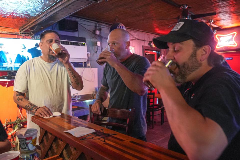 A long, wooden bar greets patrons at the 04 Lounge. Ezra Solano, left, John Powell, middle, and Ryan Hilmer had drinks at the bar in February.