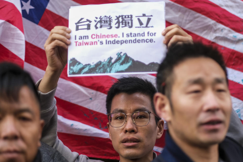 A supporter of Taiwan holds a sign while gathered with others outside a hotel where Taiwanese President Tsai Ing-wen is expected to arrive in Los Angeles, Tuesday, April 4, 2023. (AP Photo/Ringo H.W. Chiu)