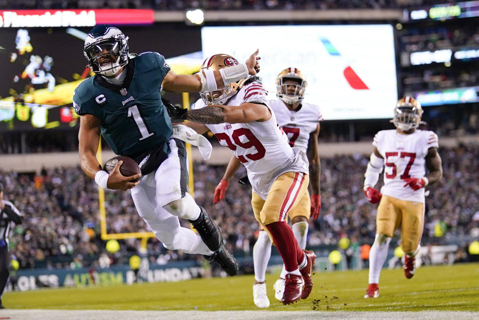 Philadelphia Eagles quarterback Jalen Hurts (1) is pushed out of bounds by San Francisco 49ers safety Talanoa Hufanga (29) during the second half of the NFC Championship NFL football game between the Philadelphia Eagles and the San Francisco 49ers on Sunday, Jan. 29, 2023, in Philadelphia. (AP Photo/Matt Slocum)