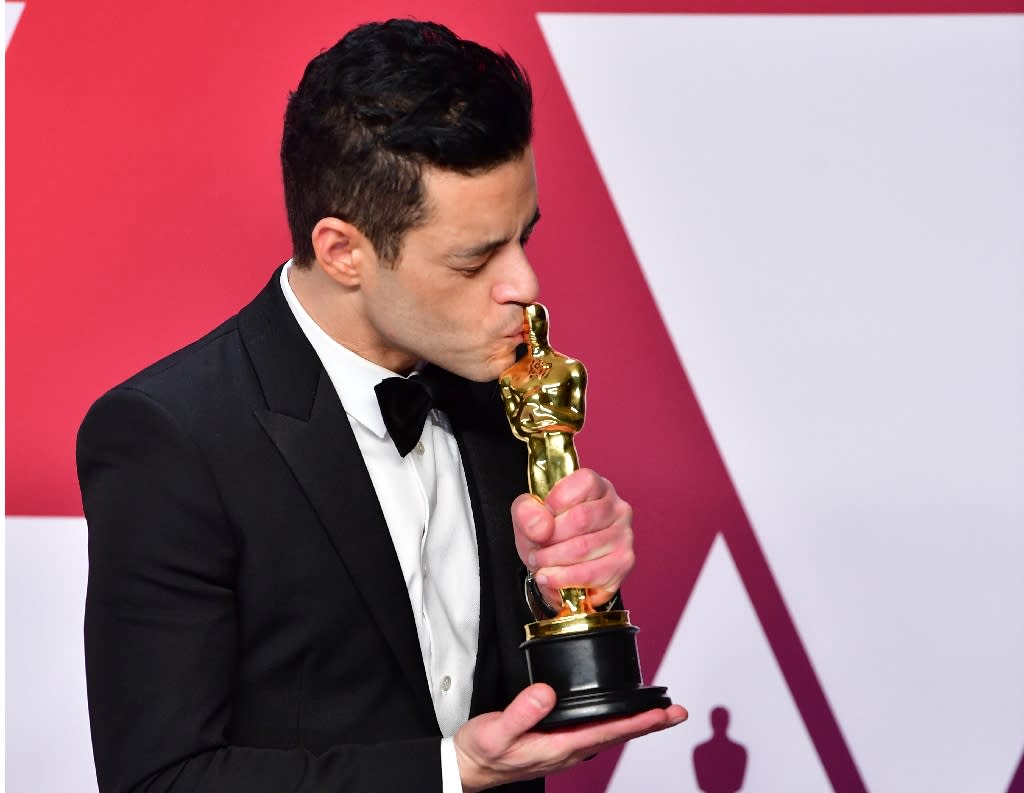 Rami Malek kisses his best actor Oscar for Bohemian Rhapsody, in which he played late Queen frontman Freddie Mercury (Credit: AFP Photo/FREDERIC J. BROWN)