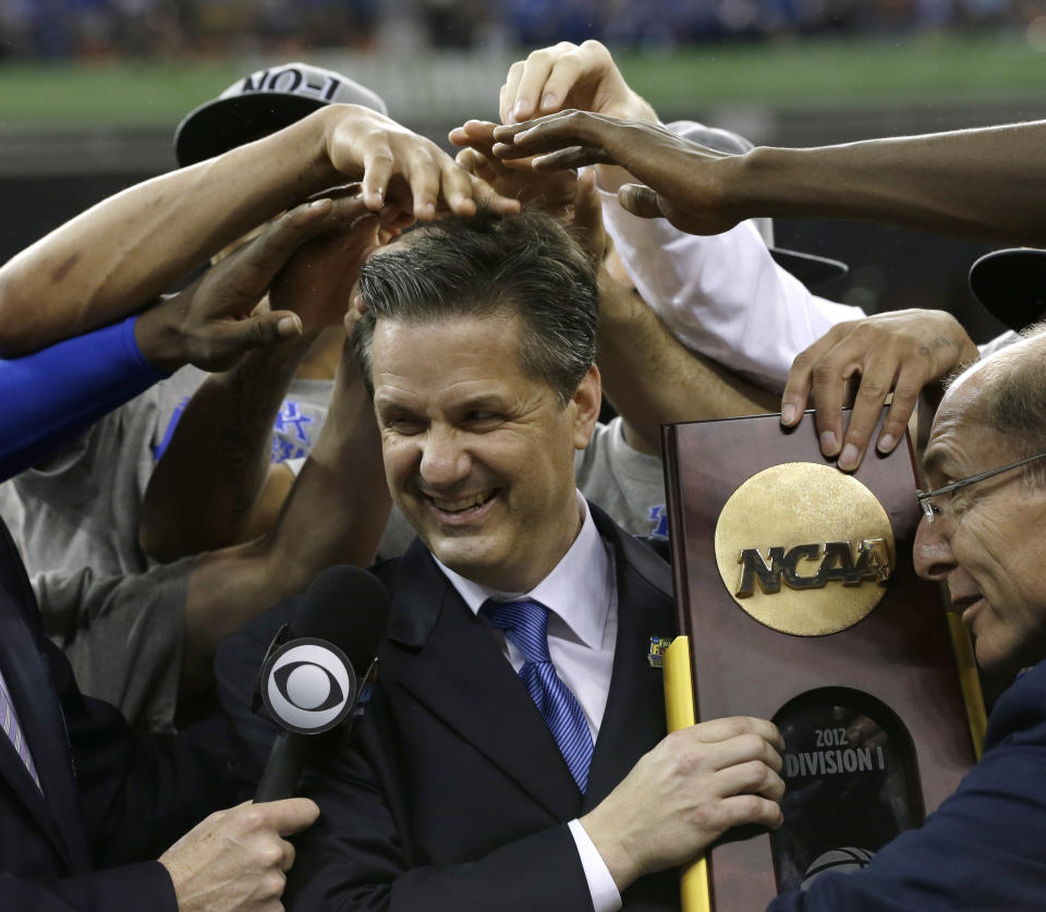 FILE - Kentucky head coach John Calipari, center, celebrates with his team after the NCAA Final Four tournament college basketball championship game against Kansas Monday, April 2, 2012, in New Orleans. Kentucky won 67-59. Calipari is stepping down as Kentucky's men's basketball coach after 15 years, saying Tuesday, April 9, 2024, on social media that the “program probably needs to hear another voice” amid reports that he's closing in on a deal with Arkansas to take over that Southeastern Conference program.(AP Photo/David J. Phillip)
