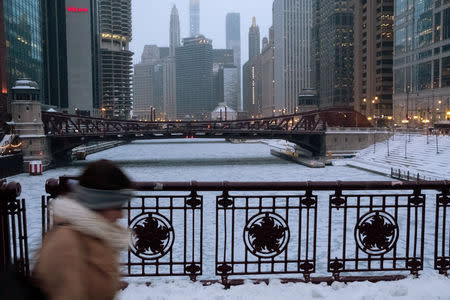 A pedestrian walks by Chicago River, as bitter cold has descended on much of the central and eastern United States, in Chicago, Illinois, U.S., January 29, 2019. REUTERS/Pinar Istek