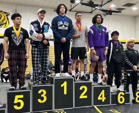 Camarillo High's Daniel Gurovich stands on the No. 1 podium after winning the 195-pound championship at the CIF-Southern Section Eastern Division finals Saturday at Capistrano Valley High.