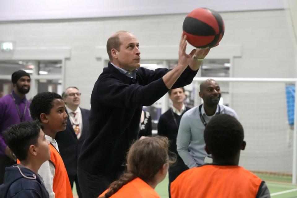 William engaged in friendly competitiveness in a game of netball and basketball in the facility’s brand-new sports hall. AP