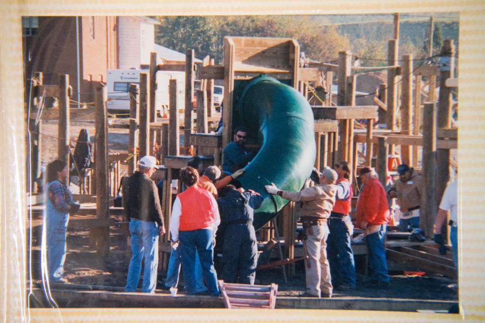 Members of the Claxton community collaborated to build a playground in 2000, an effort preserved in a photo album at the Claxton Community Center.
