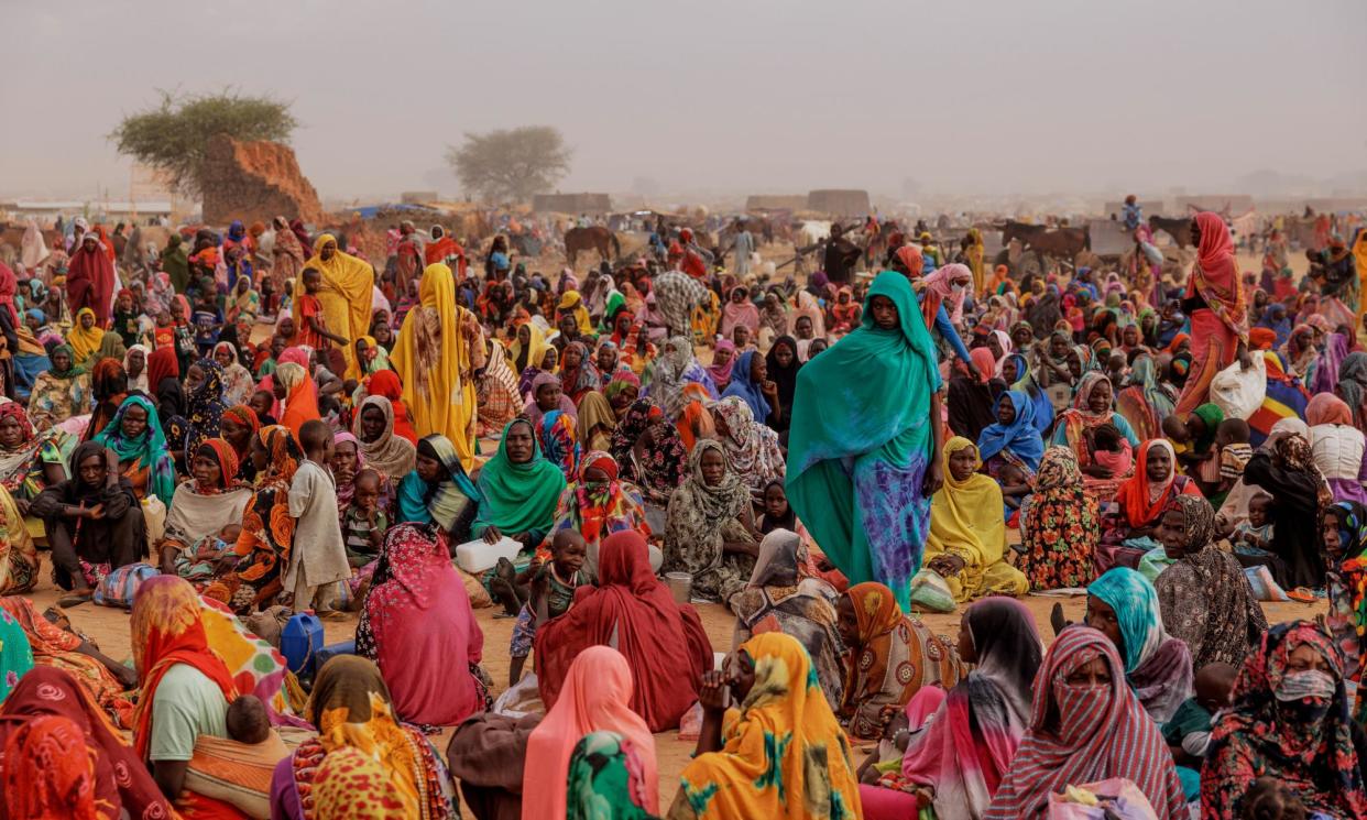 <span>Refugees wait for a food distribution point to open at a camp in Adré, Chad, on 22 April. More than 8 million people have been displaced since fighting erupted between the RSF and Sudan’s military in April 2023. </span><span>Photograph: Dan Kitwood/Getty Images</span>