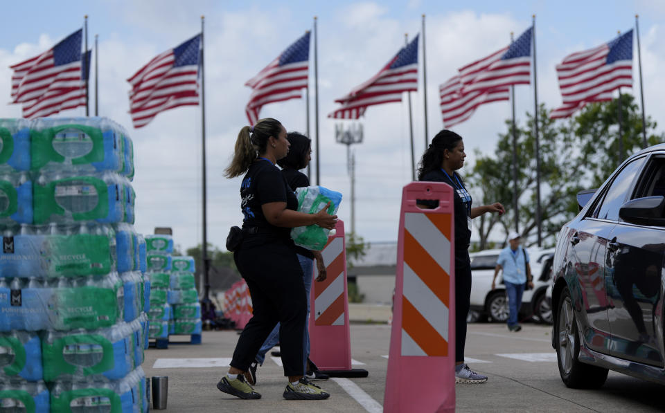 Staff at Lakewood Church hand out water and operate a cooling station in Houston, Tuesday, July 9, 2024. The effects of Hurricane Beryl left most in the area without power. (AP Photo/Eric Gay)