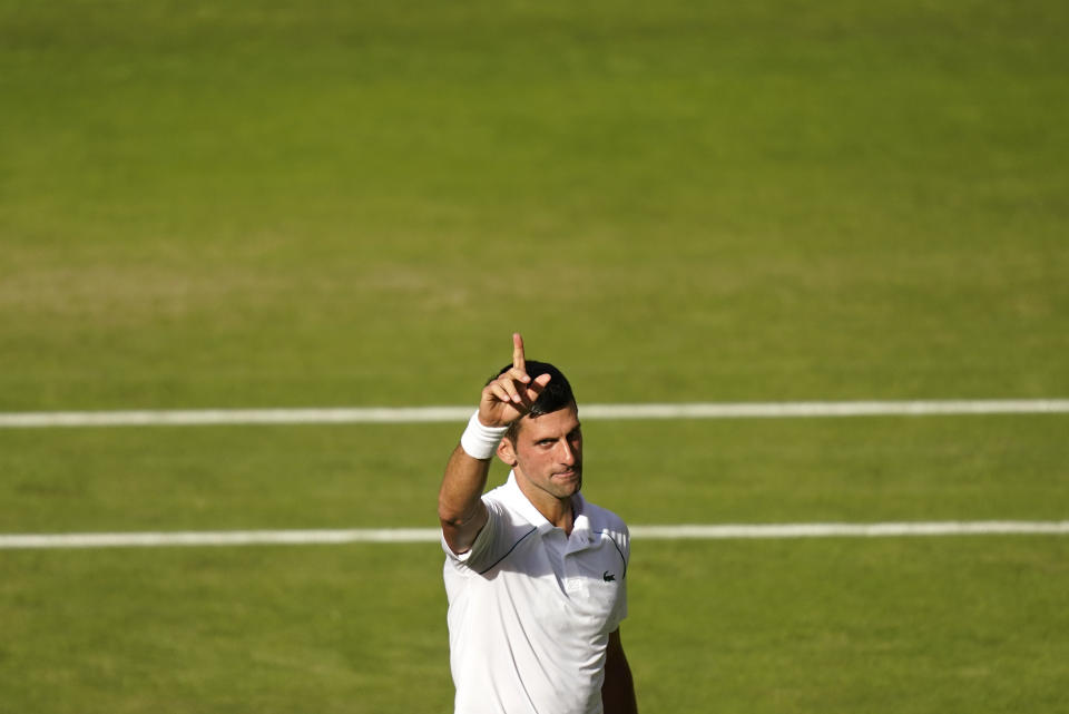 Serbia's Novak Djokovic celebrates after beating Britain's Cameron Norrie in a men's singles semifinal on day twelve of the Wimbledon tennis championships in London, Friday, July 8, 2022. (AP Photo/Gerald Herbert)