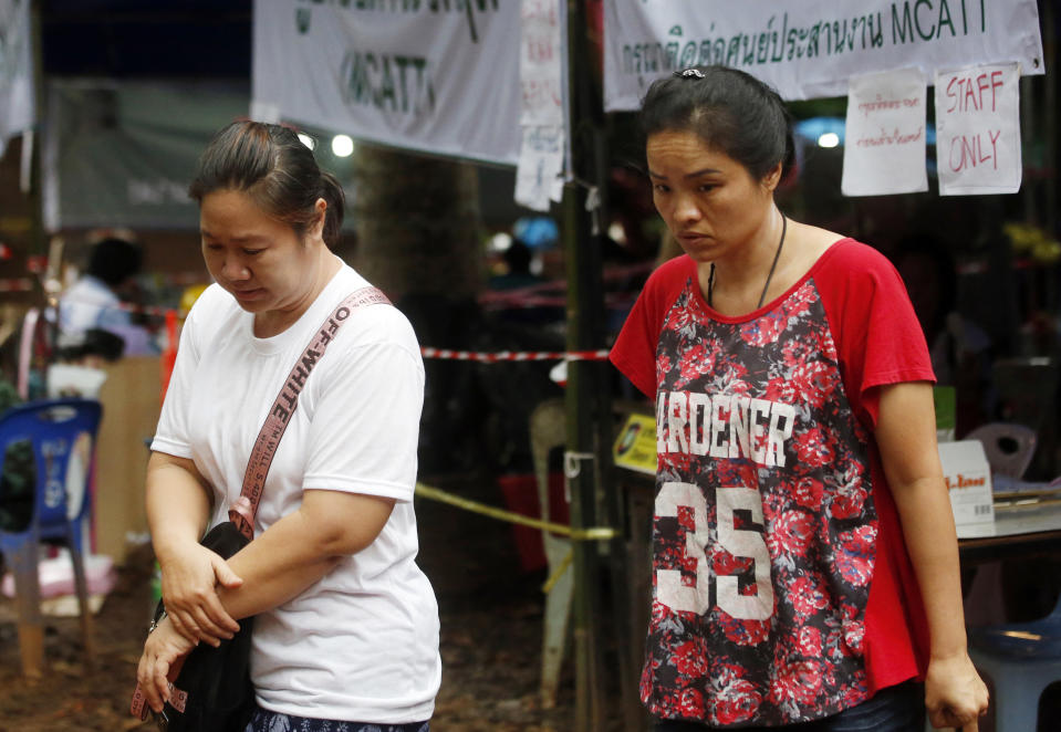 Family members walk near a cave where where the boys and their coach have been trapped since June 23, in Mae Sai, Chiang Rai province, in northern Thailand. Source: AP Photo/Sakchai Lalit