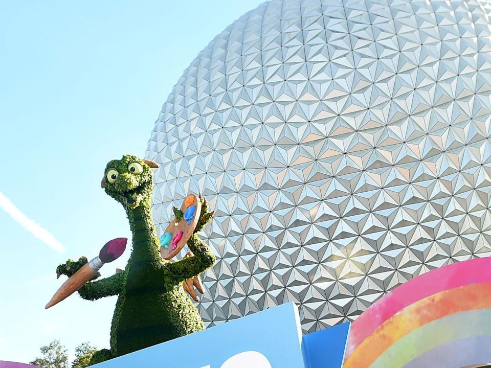 Figment made out of plants in front of epcot ball