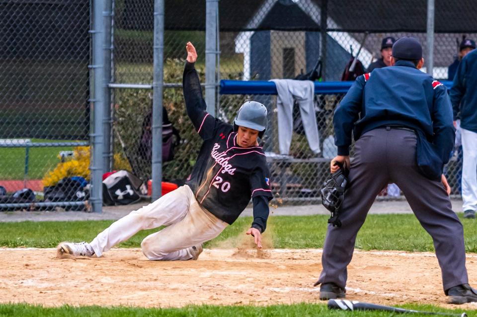 Old Rochester's Jeff Radek slides in safely for the go-ahead run in the top of the seventh.