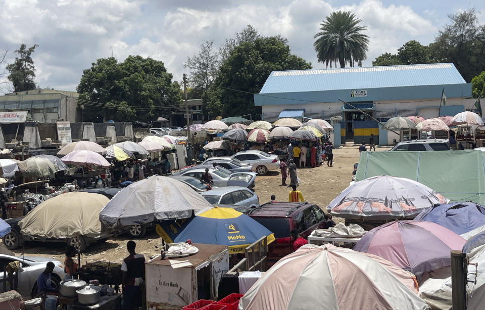 A market in Abuja, Nigeria, shown on Thursday, Aug. 17, 2023, includes a clothing shop where owner Kingsley Odafe has had to lay off employees because of declining business. One culprit for his troubles stands out: The U.S. dollar's strength against the Nigerian currency, the naira, has pushed the price of garments and other foreign goods beyond the reach of local consumers. (AP Photo/Chinedu Asadu)