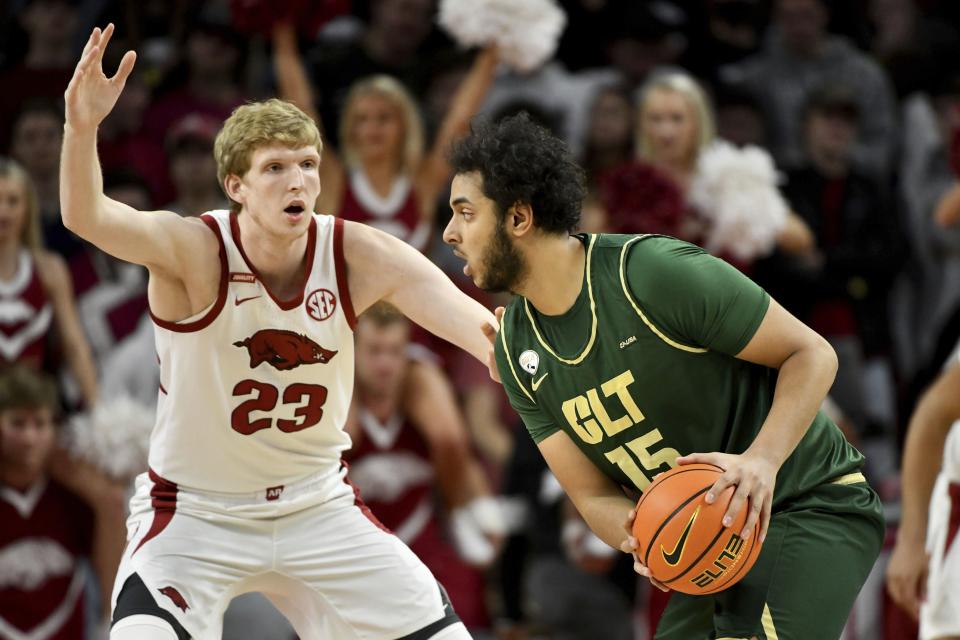 Arkansas’ Connor Vanover (23) guards Charlotte’s Aly Khalifa during a game Tuesday, Dec. 7, 2021, in Fayetteville, Ark. | Michael Woods, Associated Press